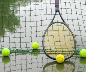 wet tennis court with tennis equipment